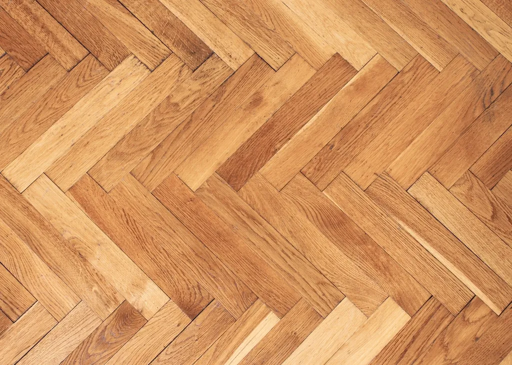 Herringbone wood floor pattern in warm honey tones